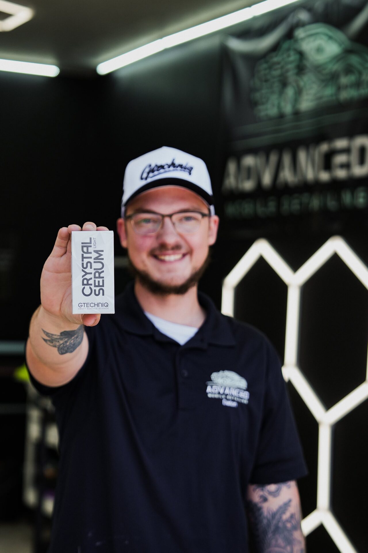 AMD owner Dalton Tyree, Gtechniq Accredited Installer, holding Gtechniq Crystal Serum Light at our Louisville KY shop