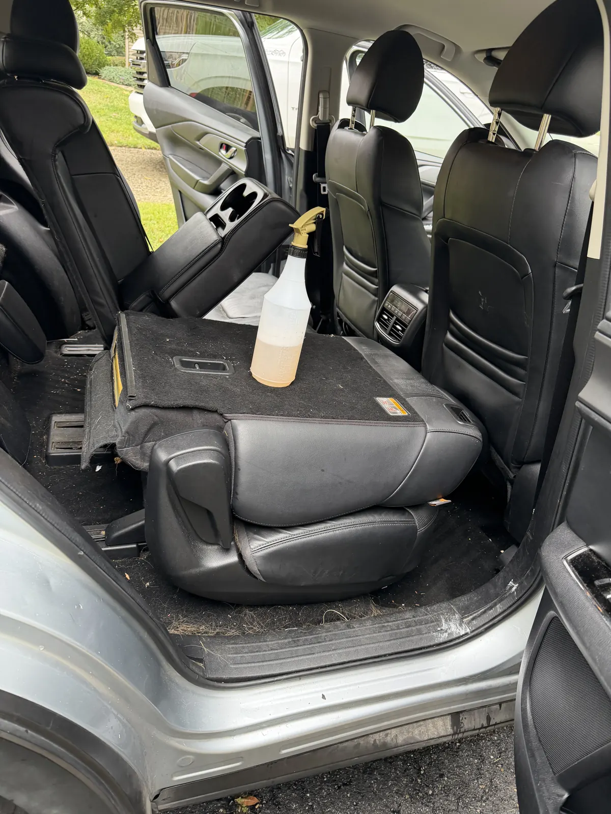 SUV third row with pet hair in the carpet before AMD pet hair removal in Louisville