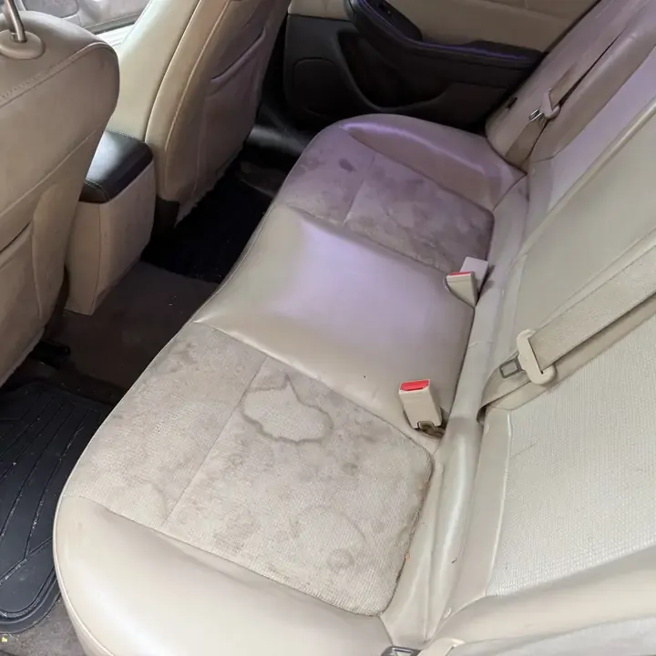 Stained rear seat before AMD upholstery cleaning in Louisville