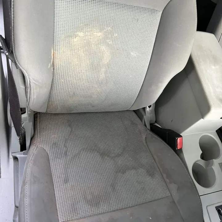 Stained cloth seat before AMD upholstery cleaning in Louisville